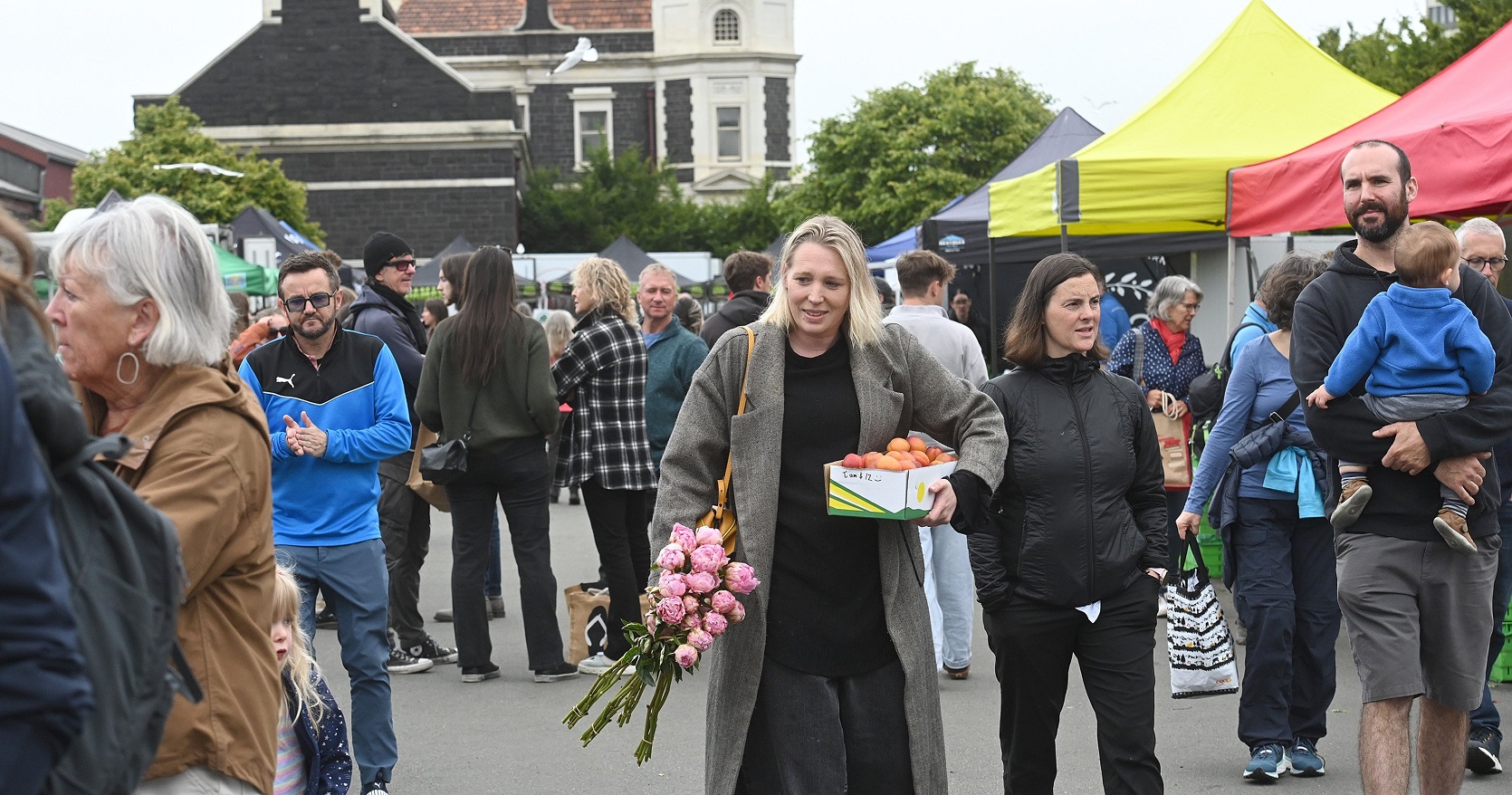 Market-goer Charmaine Reveley shops for flowers and fruit.