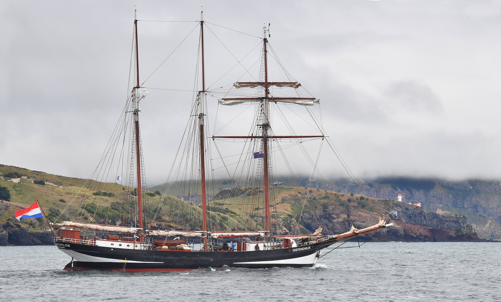 The schooner Oosterschelde motors past the Taiaora Head lighthouse on Tuesday. Photo: Stephen...