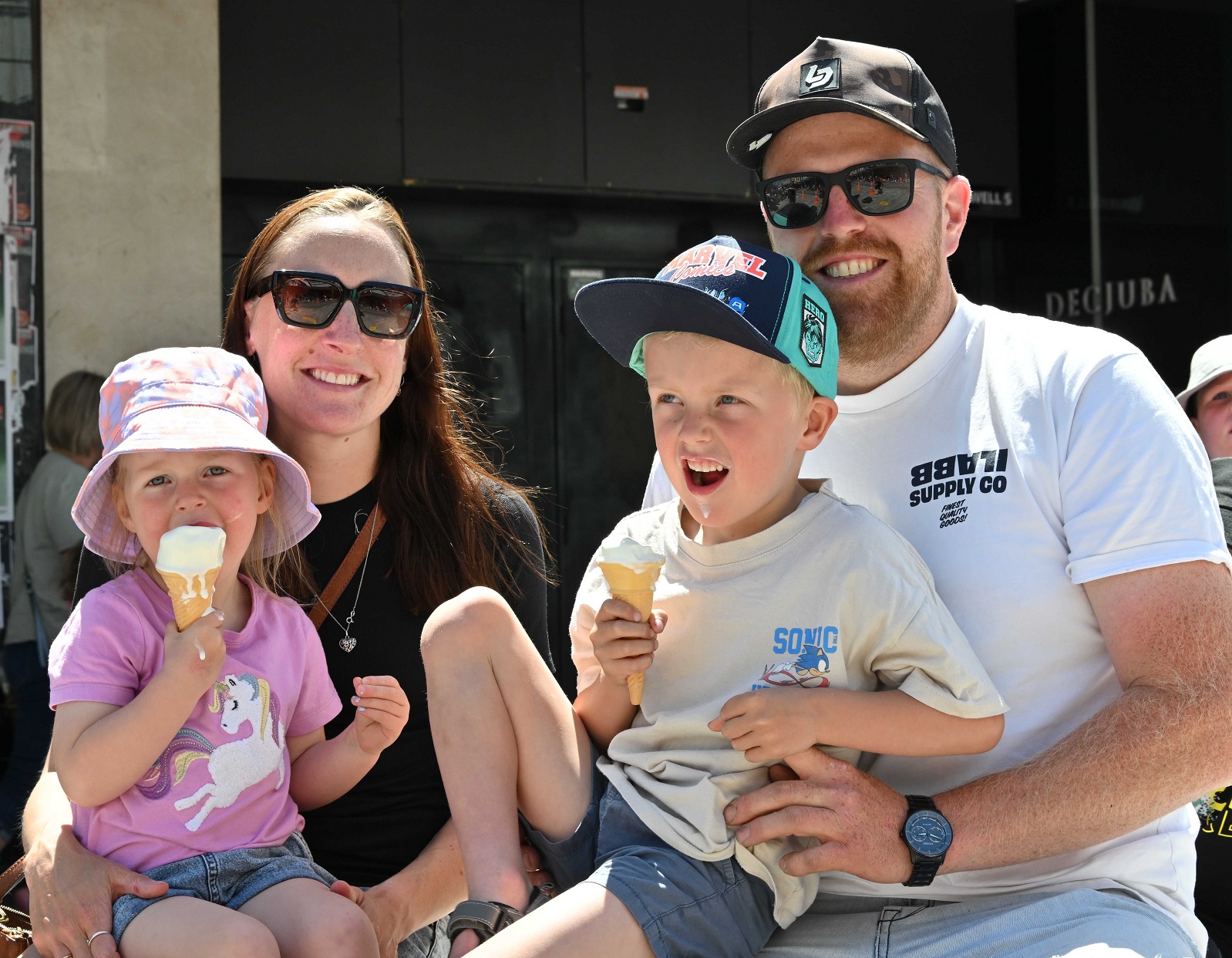 The Wilson family (from left) Laura, Jane, Eli and Jake have fun in the sun with ice creams,...