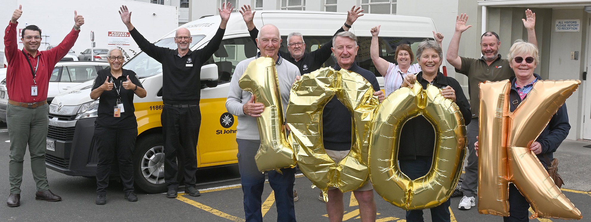 Holding balloons to celebrate the St John Health Shuttle reaching 100,000km are St John...