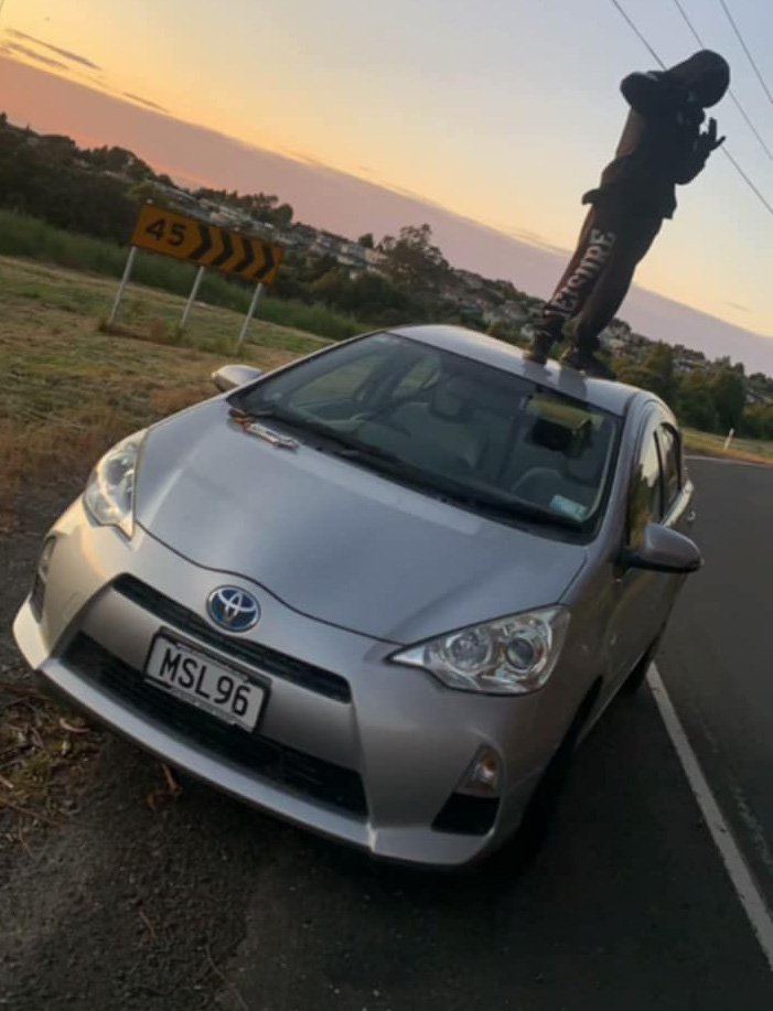 A youth stands on top of a car stolen from a Kenmure Rd address on Monday evening. Photo: supplied