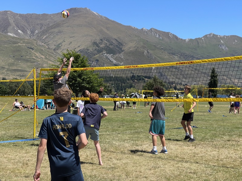 A friendly game of grass volleyball at Volley Fest 2024 in Wānaka between locals and visitors of...