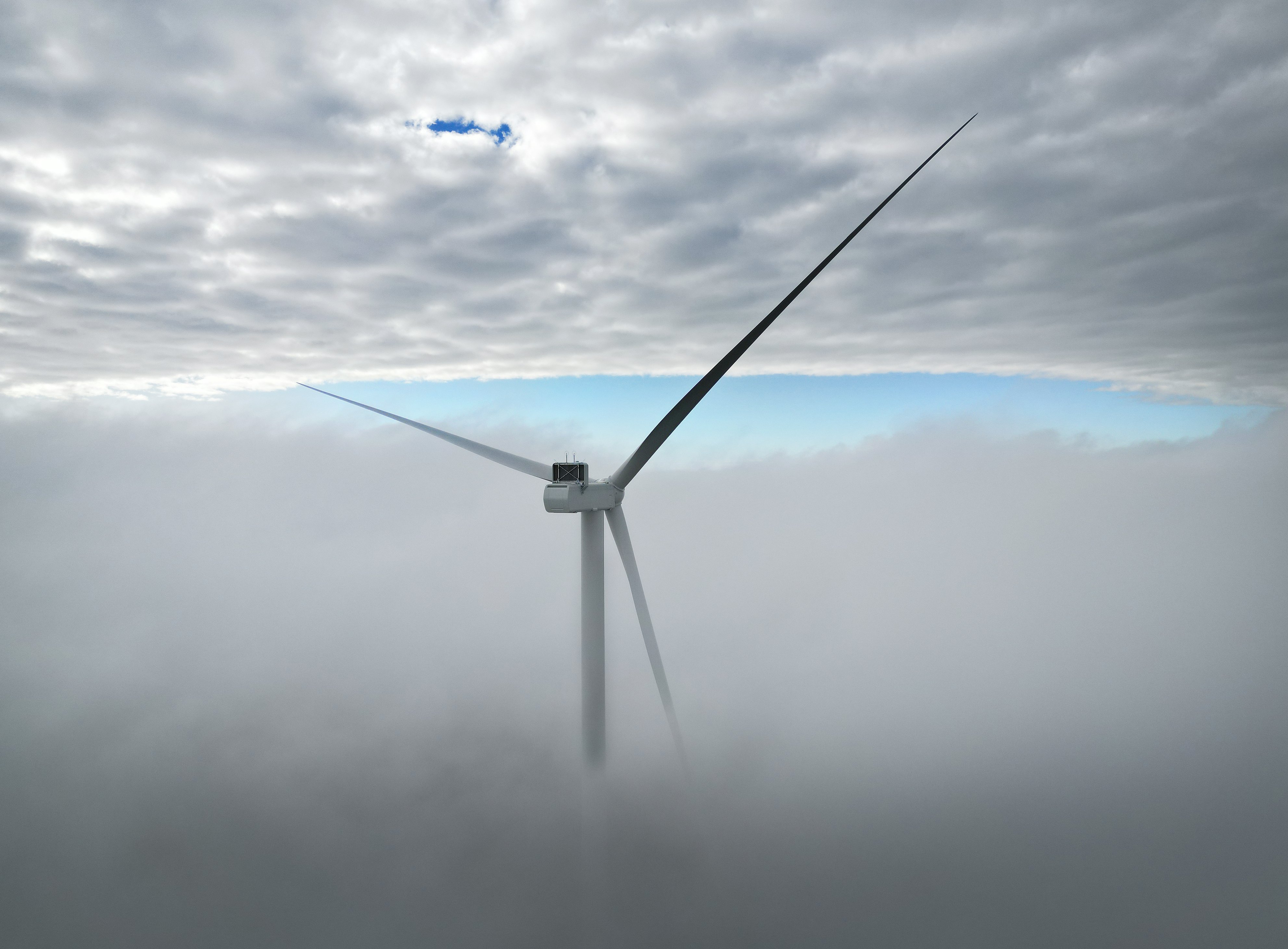 A turbine for the Kaiwera Downs wind farm, 11km east of Mataura, pokes through low cloud last...