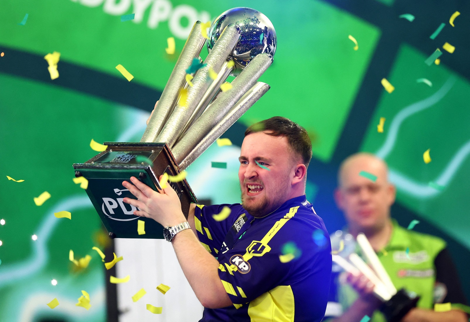 Luke Littler celebrates with the trophy after his victory. Photo: Reuters