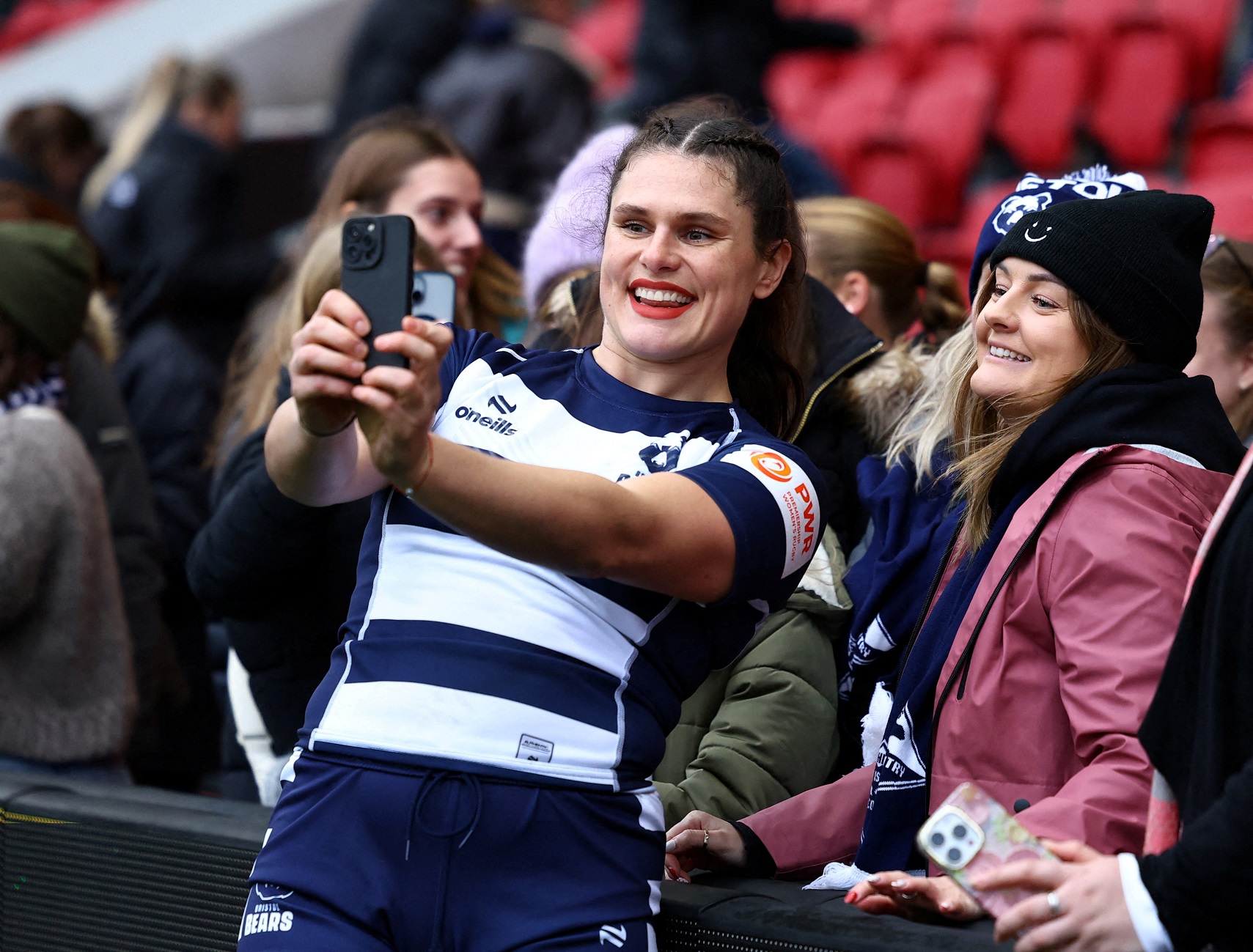 American rugby star Ilona Maher poses for a photograph with fans after making her debut for...