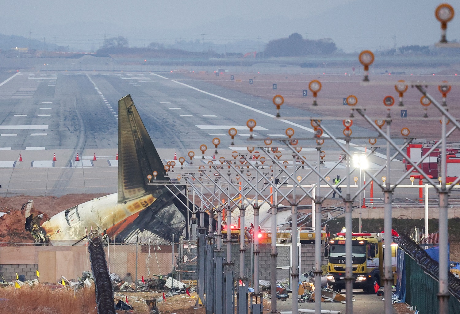 The wreckage of the Jeju Air aircraft that went off the runway and crashed lies at Muan...