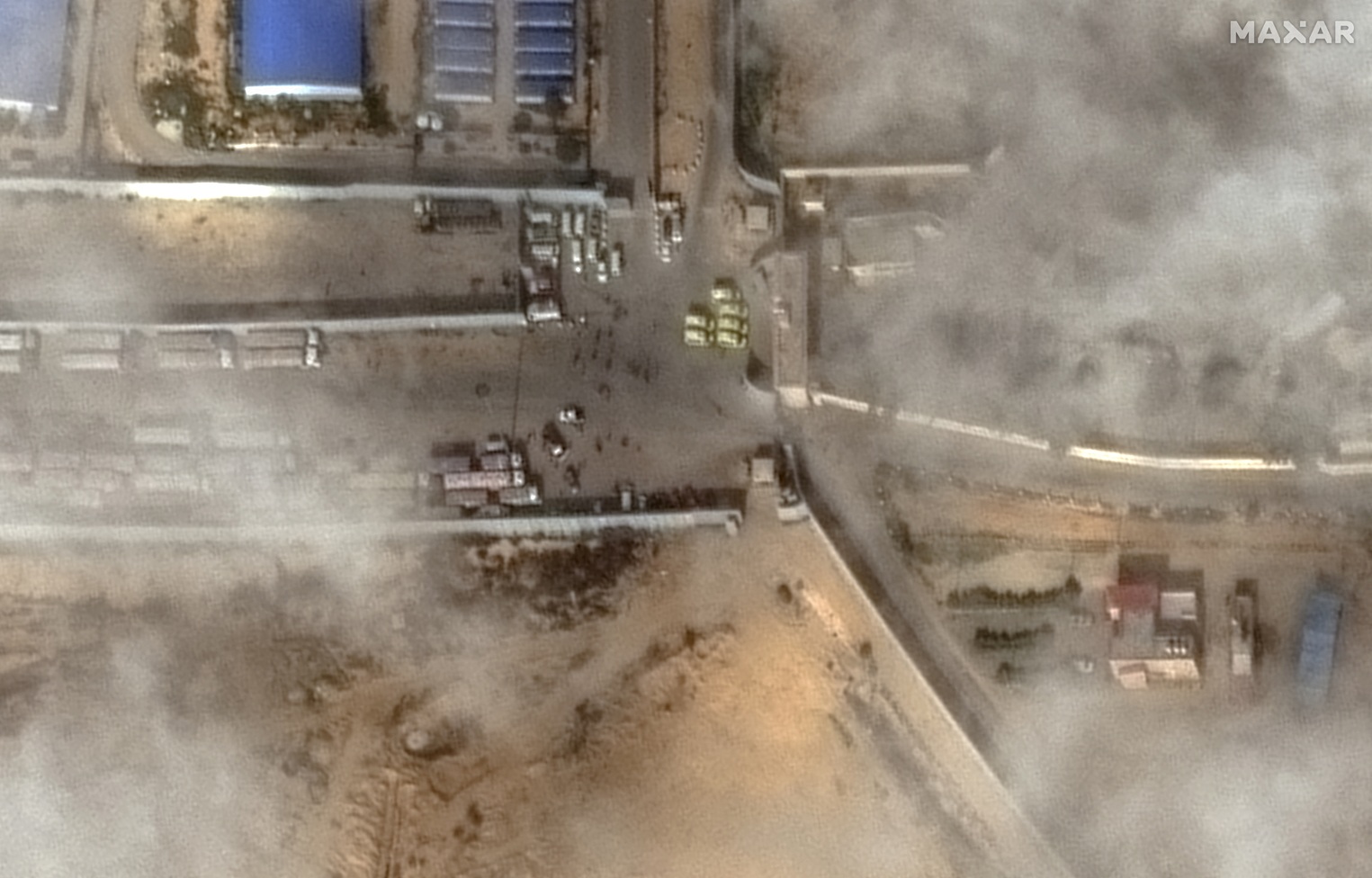 A satellite image shows aid trucks waiting at the Rafah-Egypt border. Photo: Maxar Technologies...