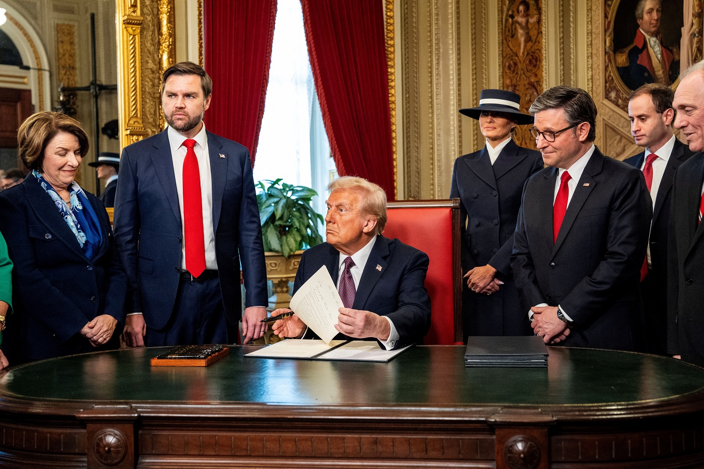 President Donald Trump speaks to his leadership team (from left) Senator Amy Klobuchar, Vice...