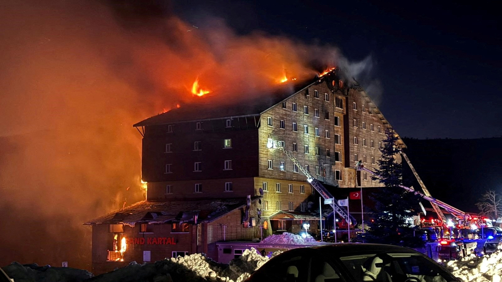 Firefighters work to extinguish a fire at a hotel in the ski resort of Kartalkaya in Bolu, Turkey...