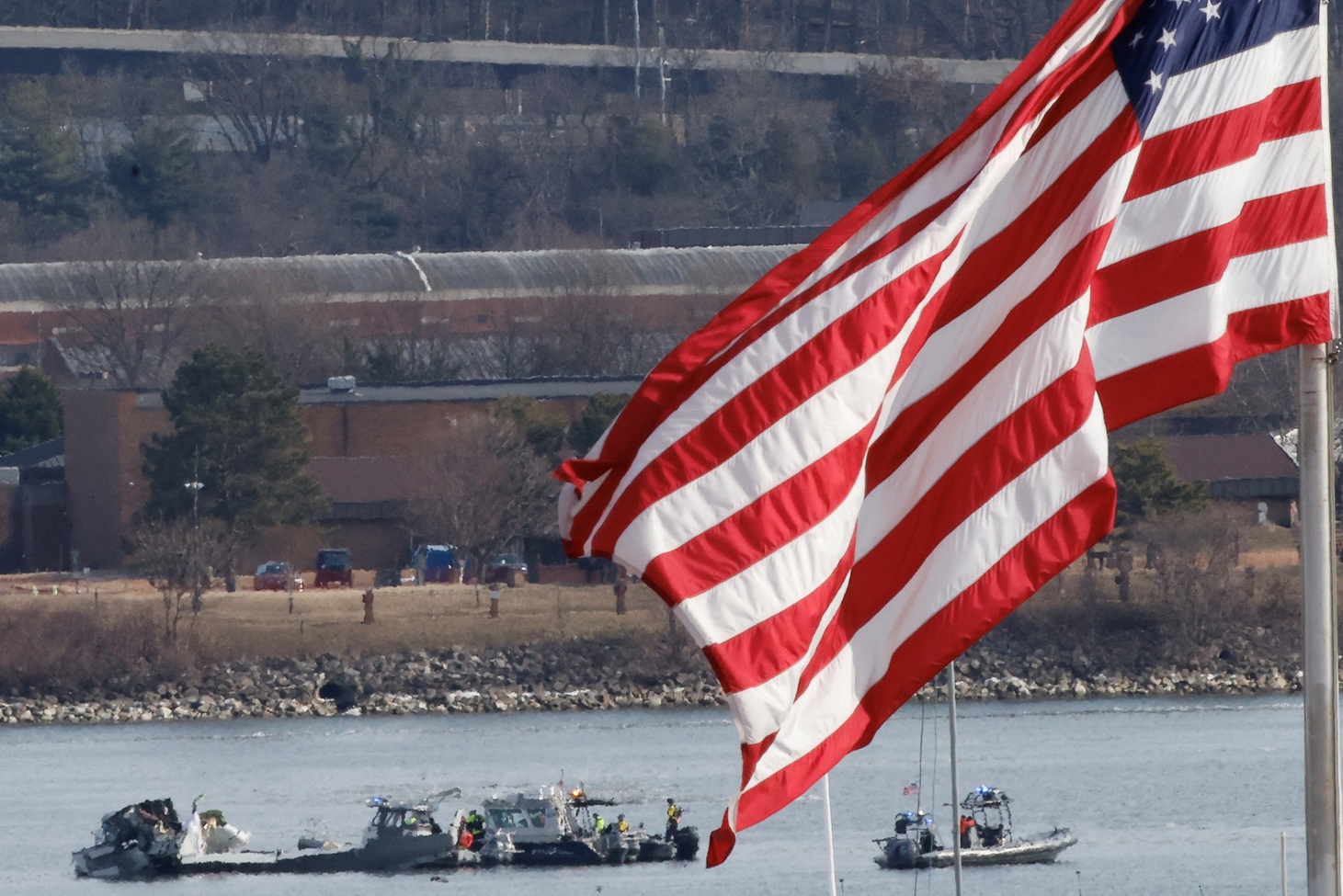 Search and rescue teams work at the scene of the crash on the Potomac River, in Arlington,...