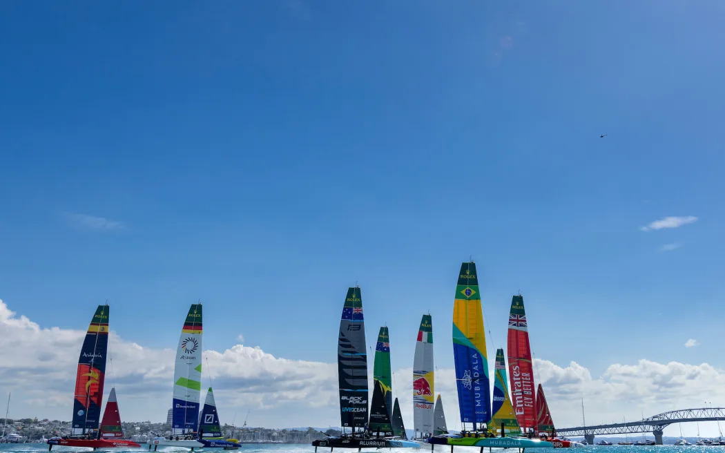 SailGP fleet passes the Auckland Harbour Bridge. Photo: Felix Diemer for SailGP