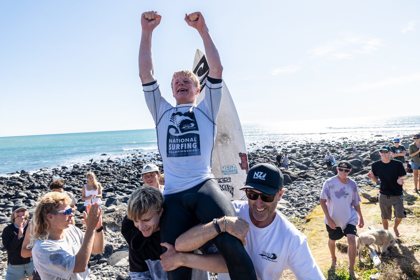 Alexis Owen is chaired along the beach by supporters after winning the New Zealand surfing title....