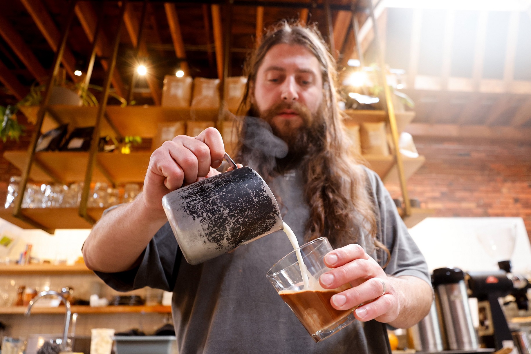 Alex Sciarrotta, owner of Narrative Coffee, makes a 6-ounce espresso and milk coffee drink in...