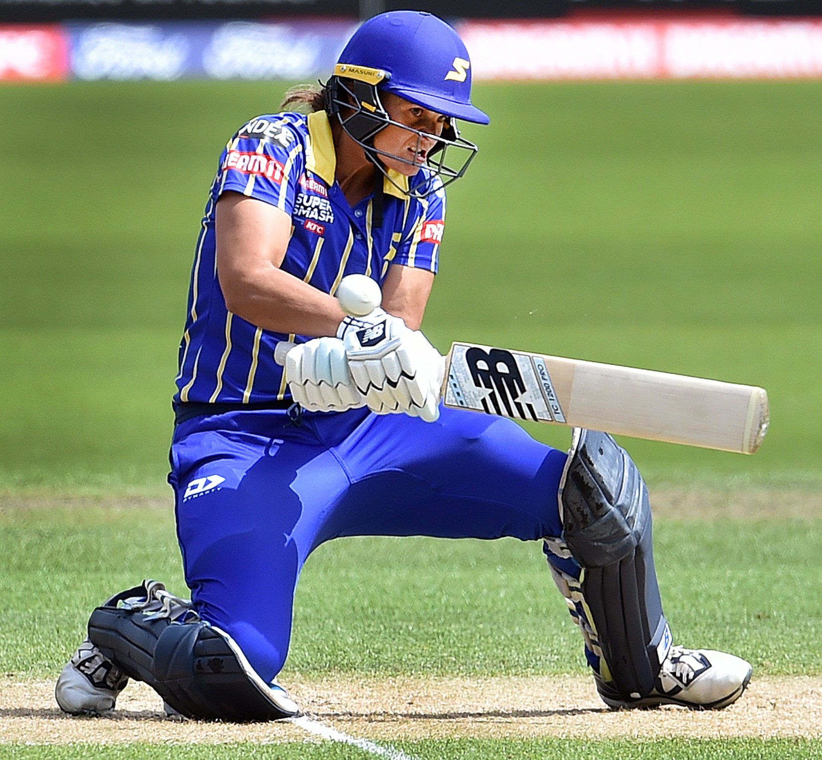 Otago Sparks batter Suzie Bates gets down on one knee to play a reverse sweep during a Super...