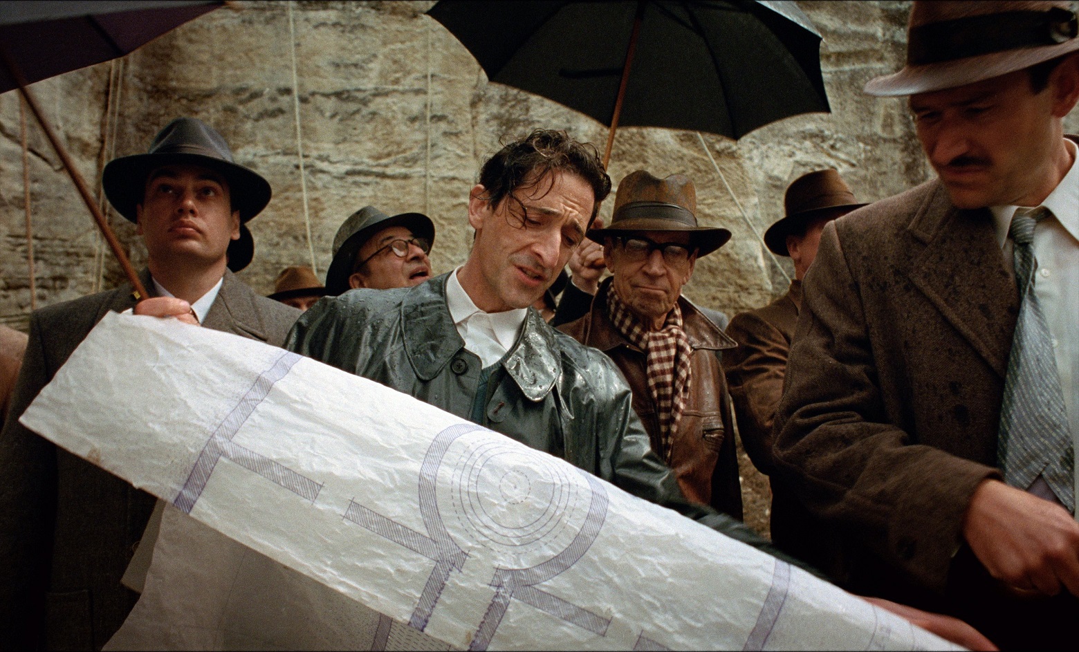 Adrien Brody, centre, in a scene from The Brutalist. Photo: A24/TNS