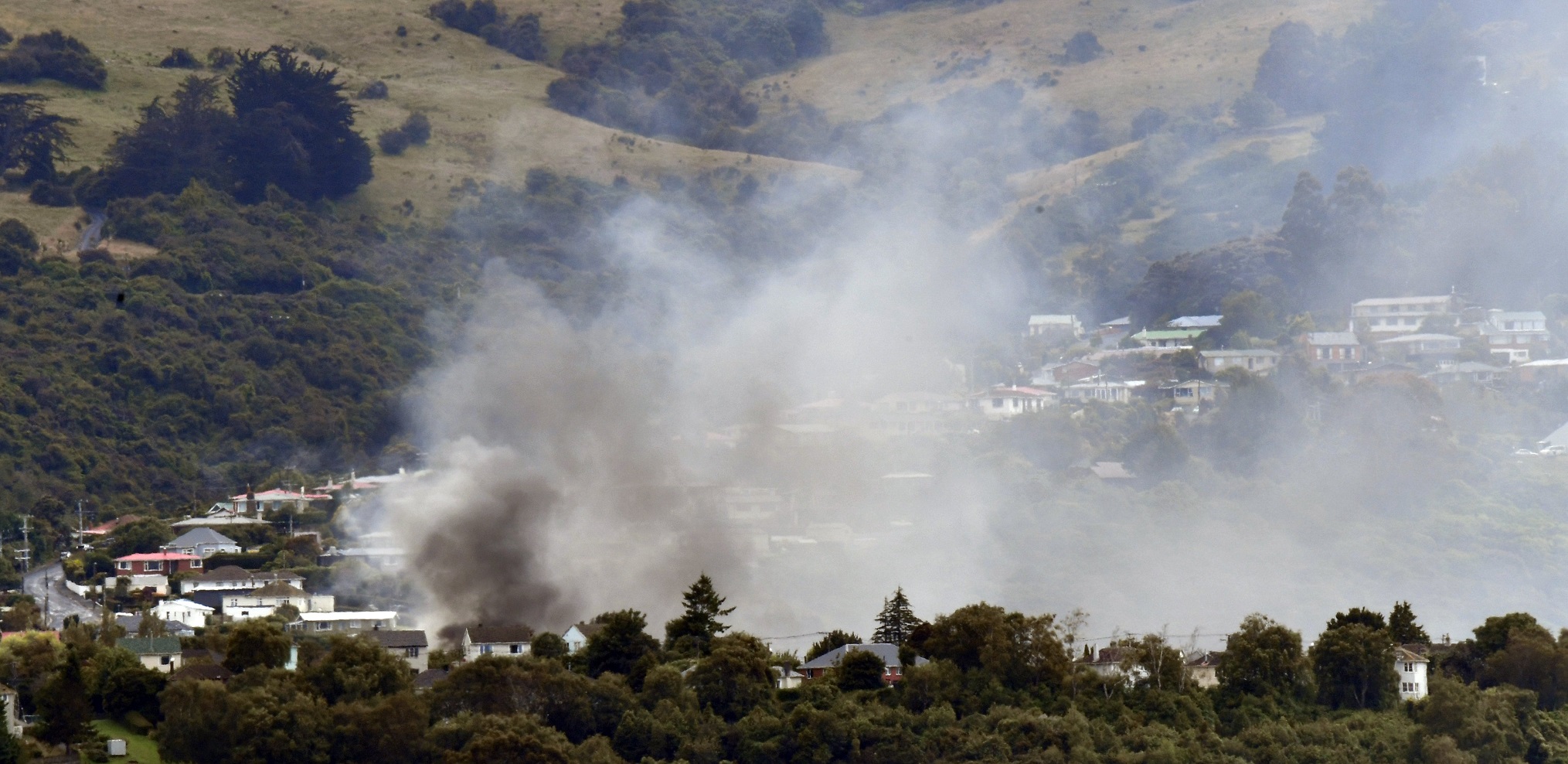 Smoke billows from a garage fire in Hislop St, Pine Hill, yesterday morning. Photos: Peter McIntosh