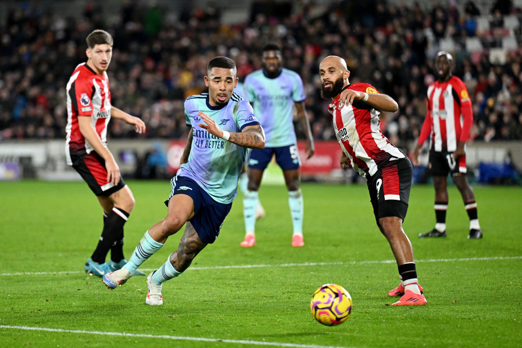 Gabriel Jesus of Arsenal runs with the ball under pressure from Bryan Mbeumo of Brentford in this...