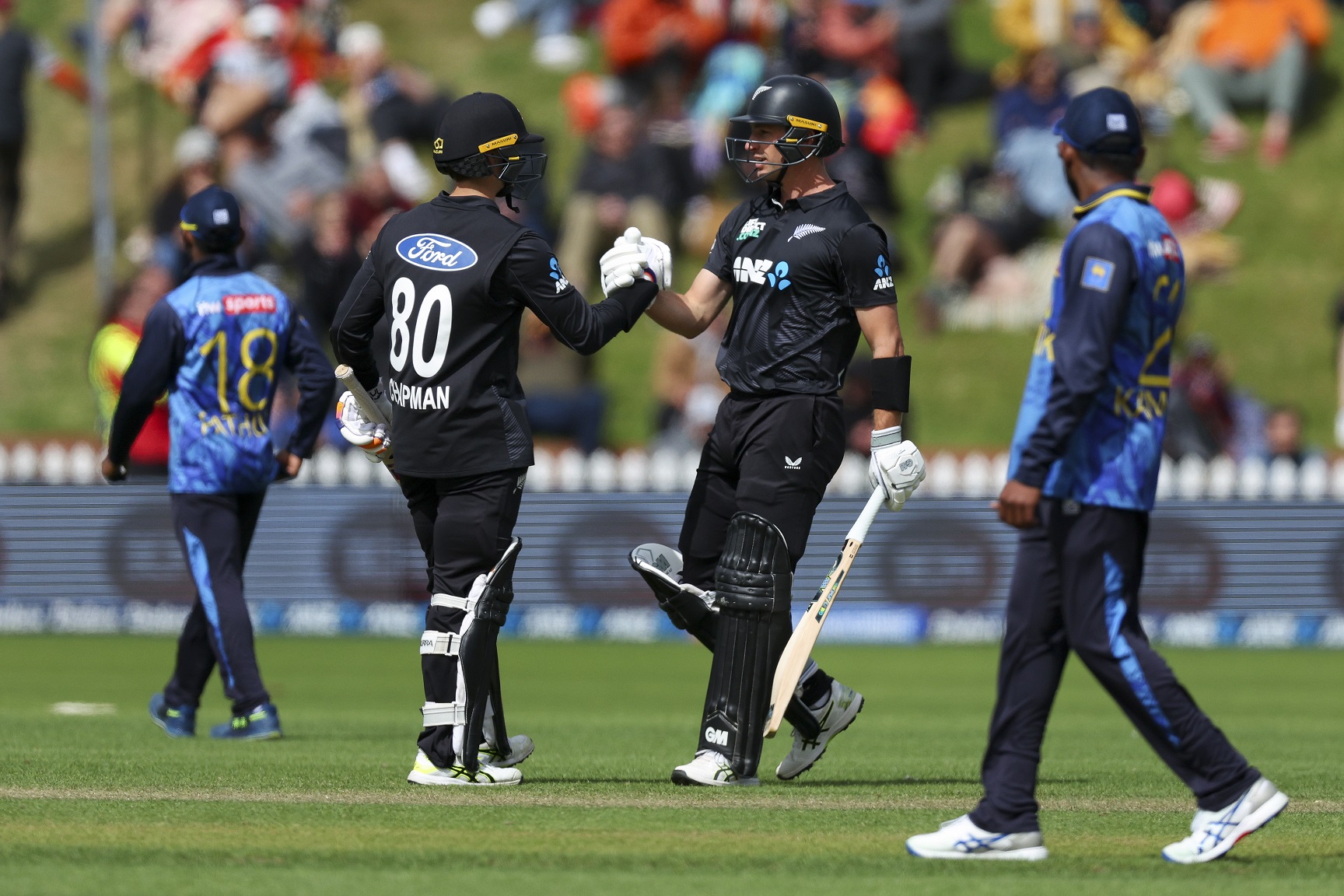 New Zealand's Will Young celebrates scoring 50 runs with Mark Chapman during the first ODI...