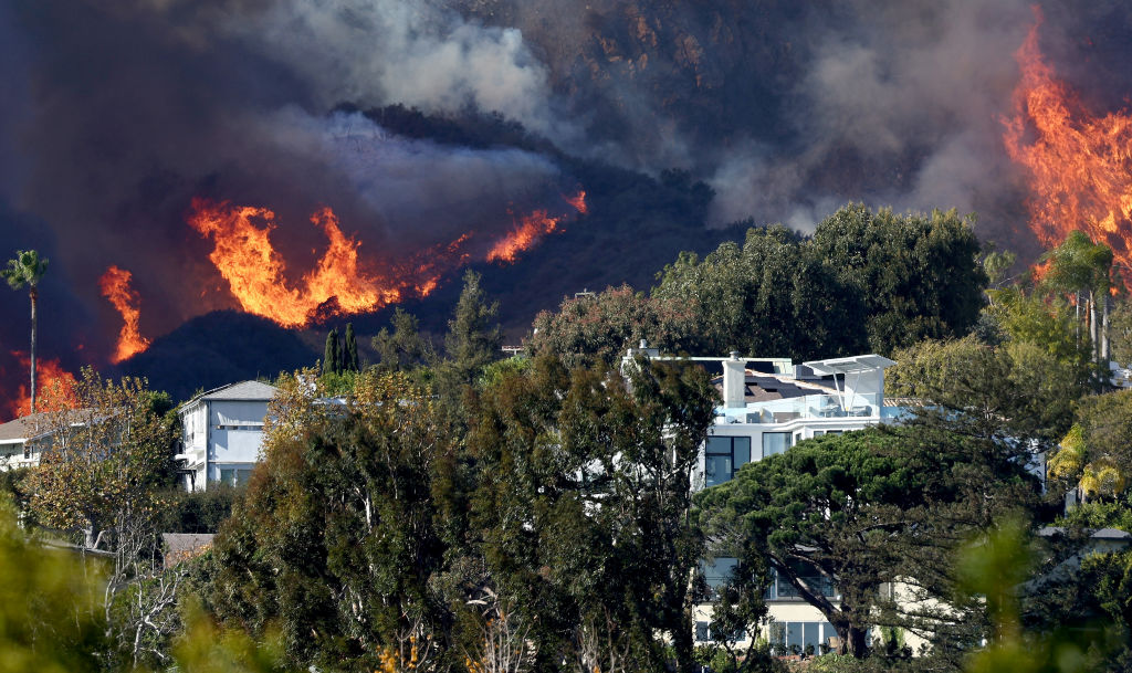 A wildfire burns near homes amid a windstorm in Pacific Palisades, California. Photo: Getty Images