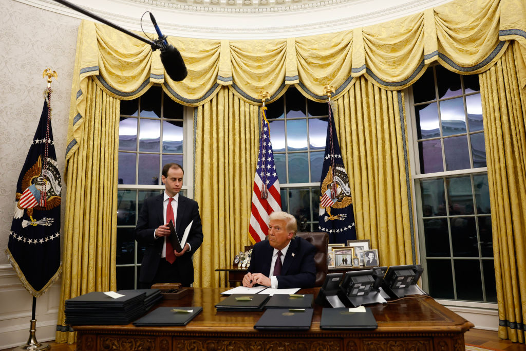 United States President Donald Trump signs executive orders in the Oval Office today. Photo:...