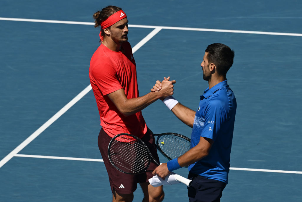 Novak Djokovic (right) of Serbia shakes hands with Alexander Zverev of Germany shake hands...