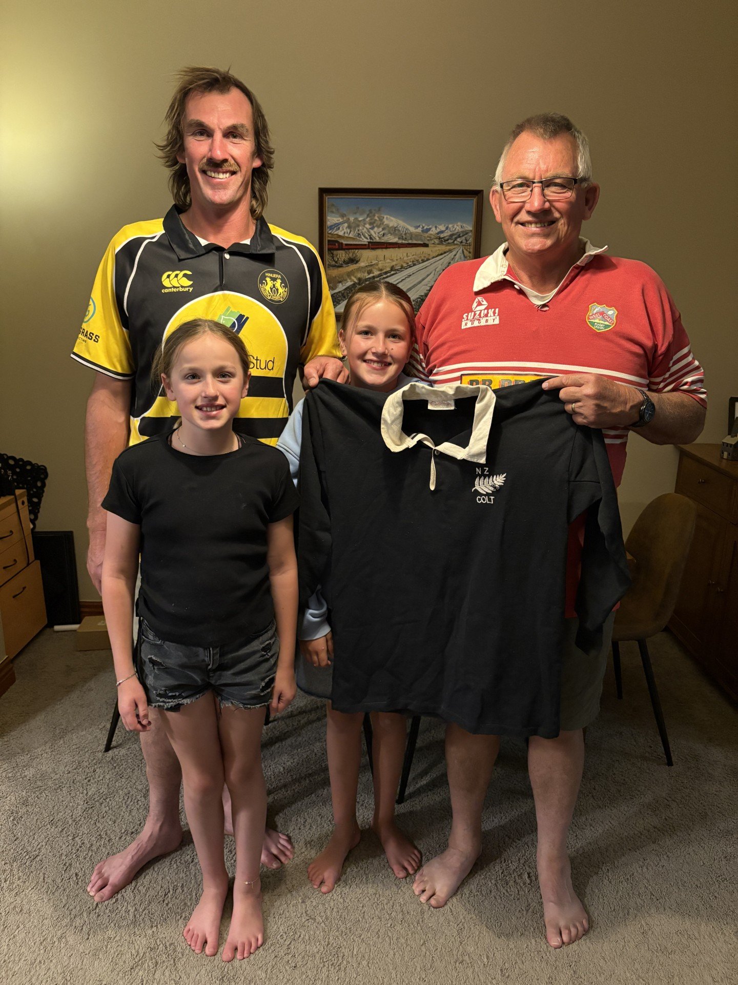 Graham McGurk proudly holds up his 1981 New Zealand Colts jersey, alongside his son Jonathan and...