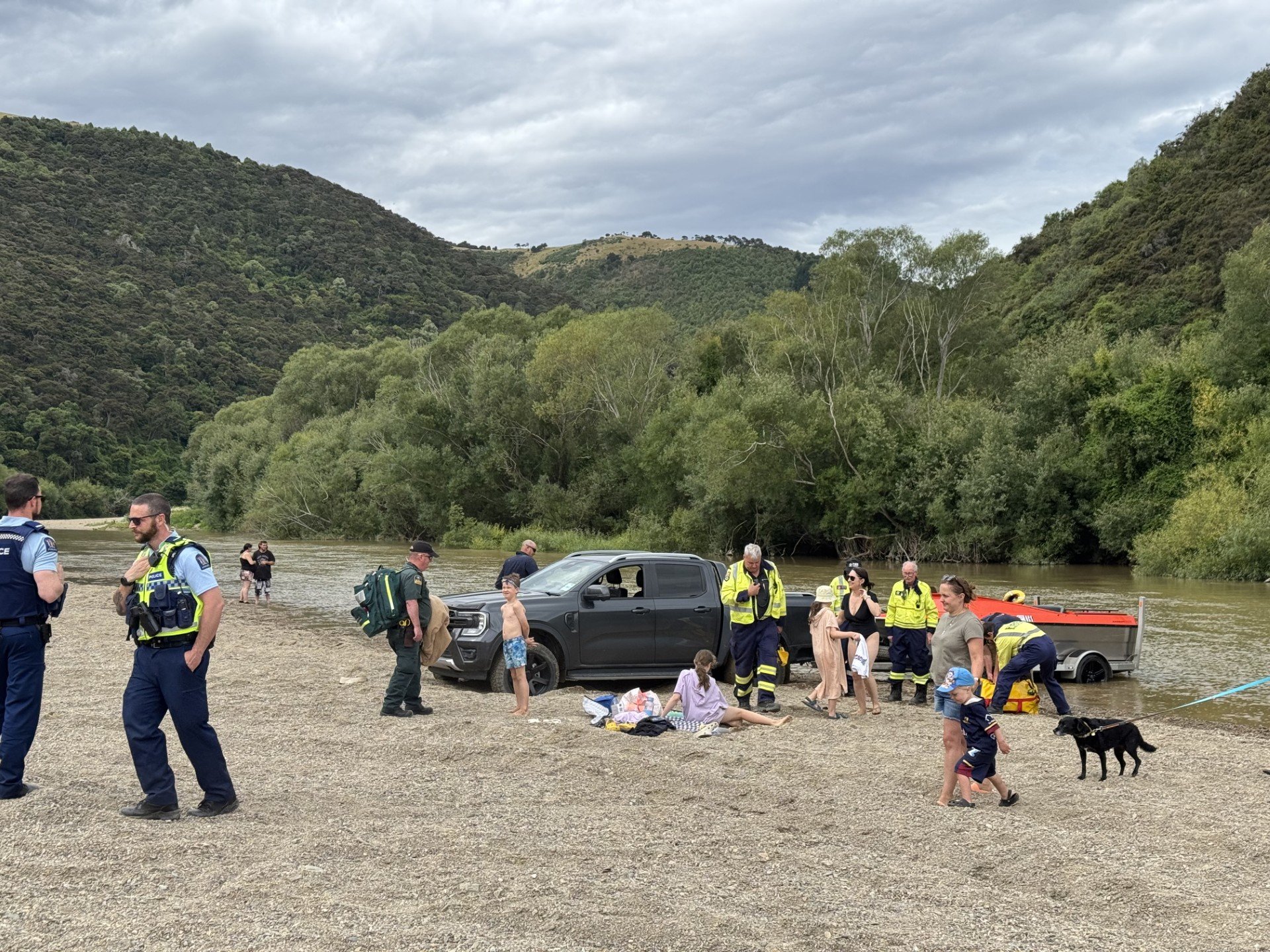 Emergency services rescue a boy from the Taieri River at Outram Glen yesterday. PHOTO: HAYDEN MEIKLE