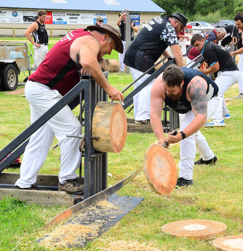 Nic Corbin, of Christchurch, completes his sawing in a single saw event, assisted by his father...