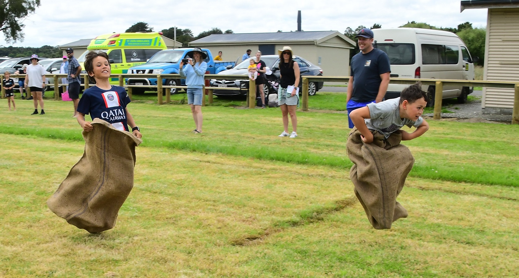 Ali Peterson, 10, of Riverton, jumps to a win in a sack race held during the New Year’s Day...