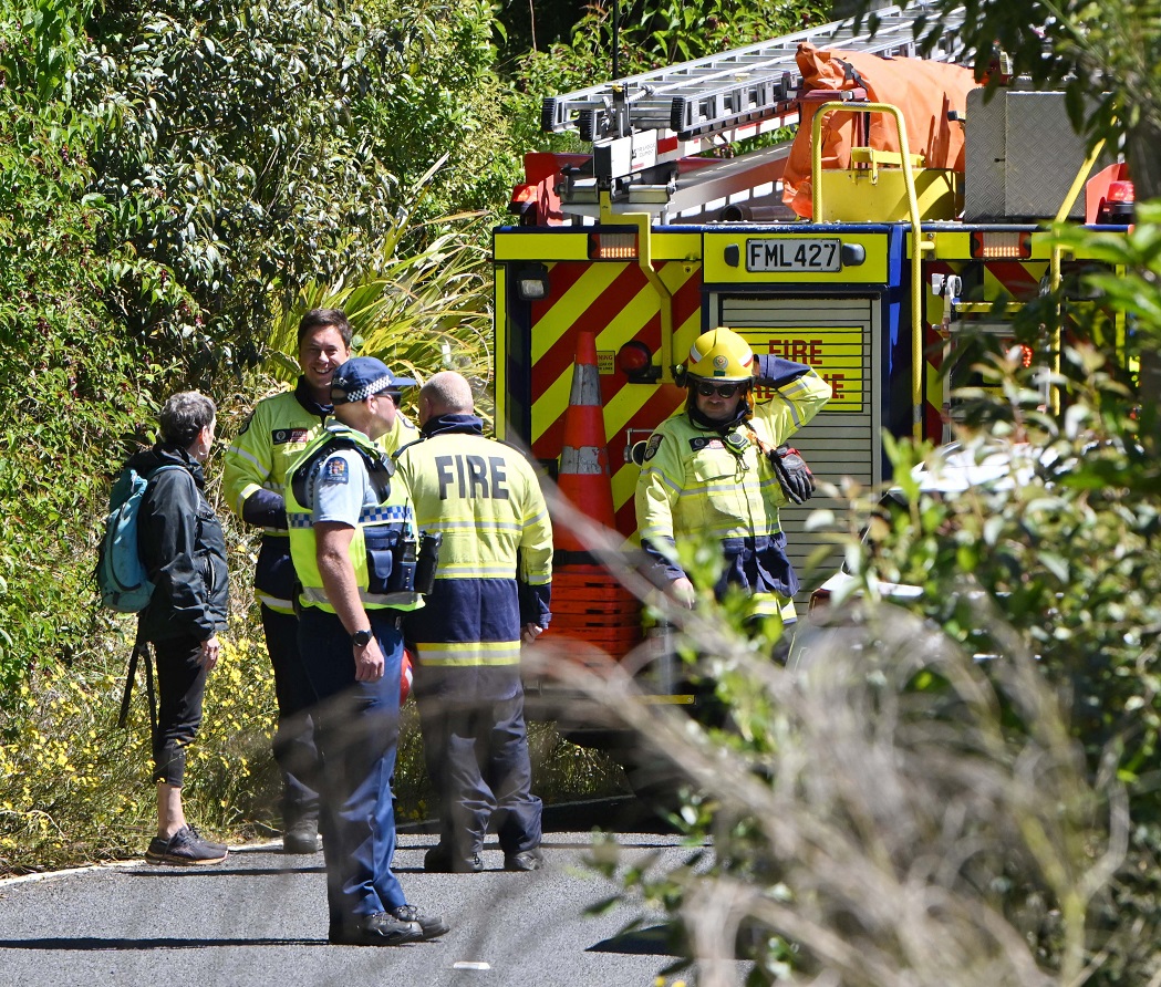 Emergency services personnel talk to a woman who got lost while walking the Organ Pipes track on...