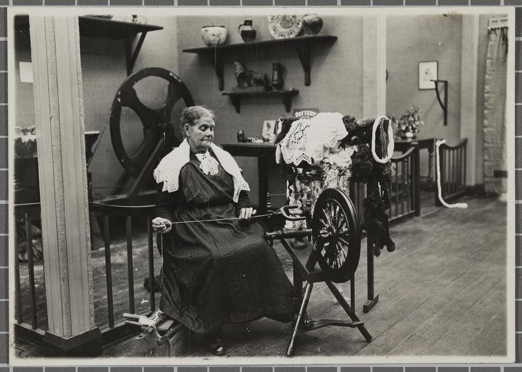 A woman demonstrates spinning wool at the New Zealand and South Seas Exhibition of 1925-26. Photo...