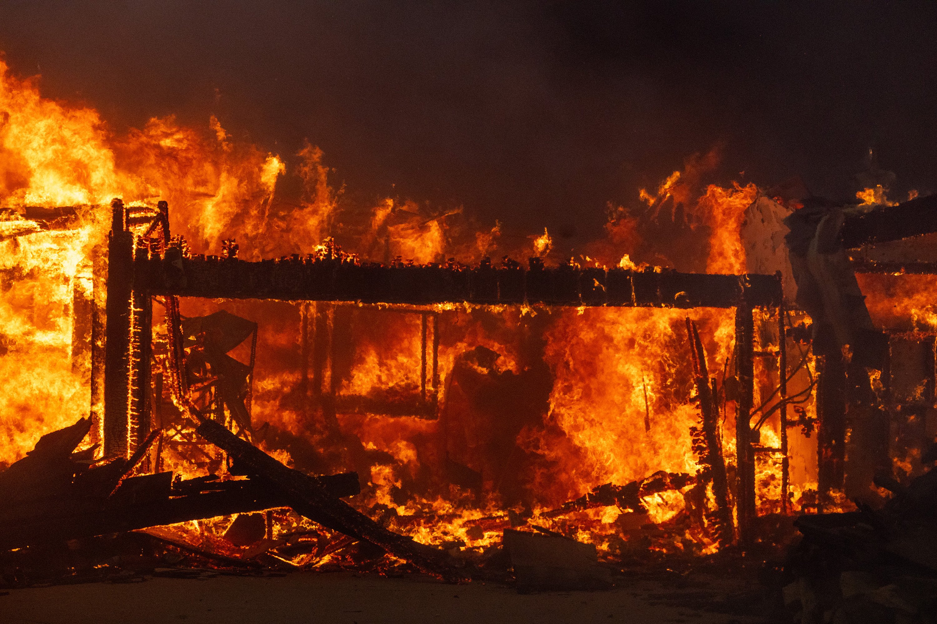 The Palisades fire destroys a home on El Medio Avenue on Tuesday, Jan. 7, 2025, in Pacific...