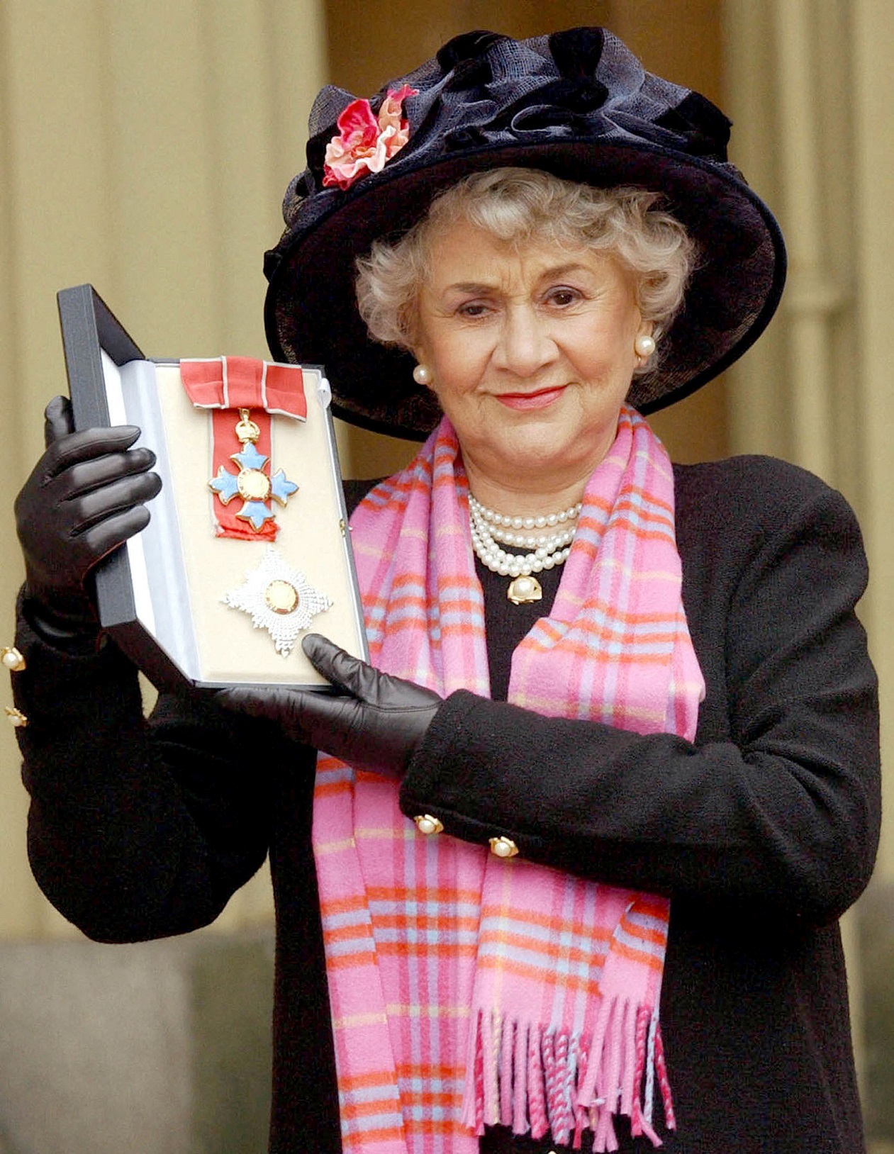 Joan Plowright poses for photographs after being made a dame in 2004. Photo: Reuters