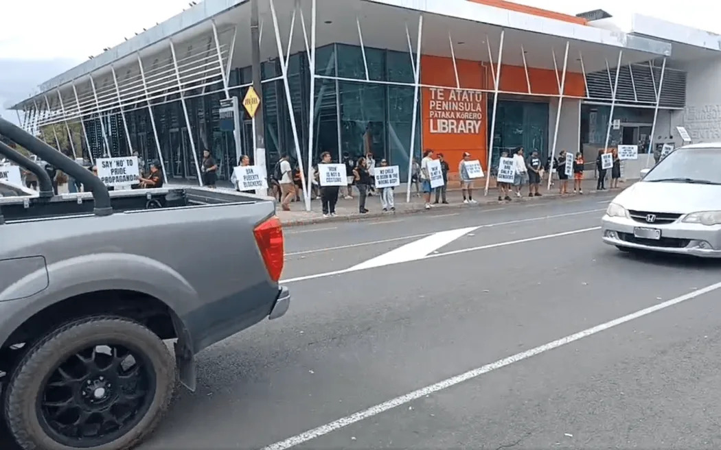 Members of the Destiny Church's "Man Up" group holding a protest outside Te Atatu library. Photo:...