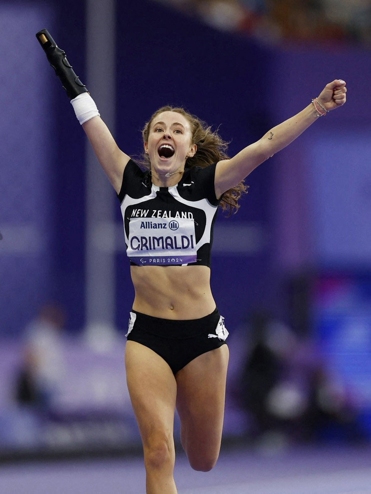 Anna Grimaldi celebrates winning gold in the women’s 200m-T47 final at the Paralympics at Stade...