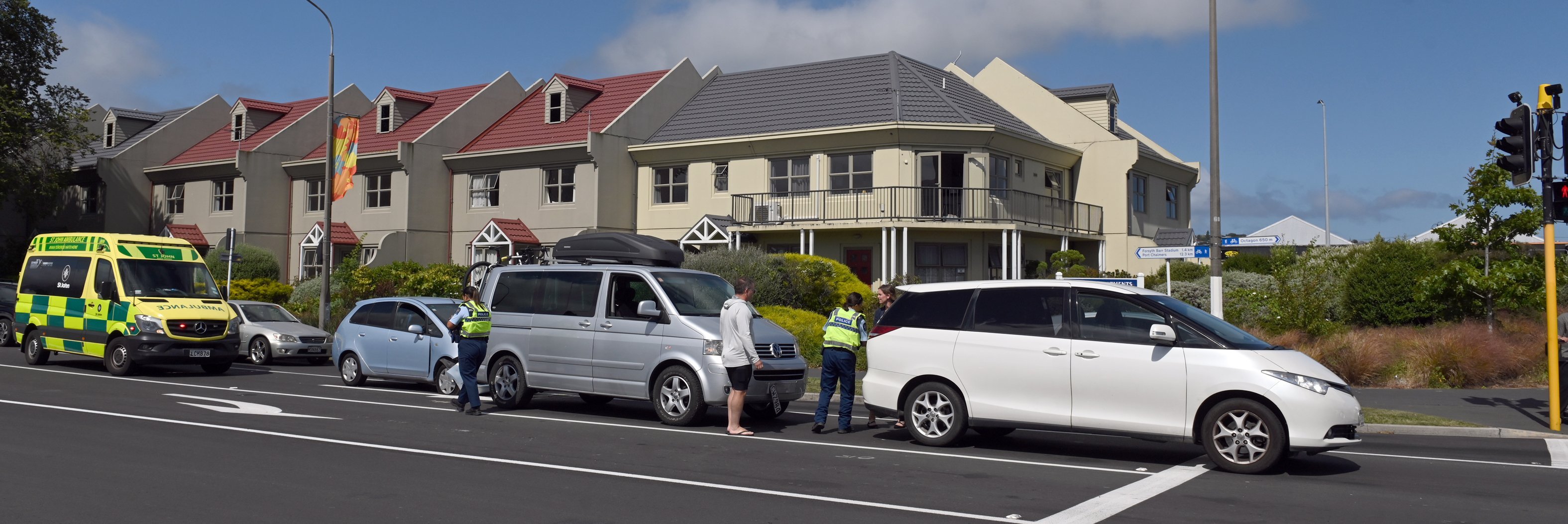 Police and ambulance officers attend a 3-car nose-to-tail accident at the intersection of Anzac...