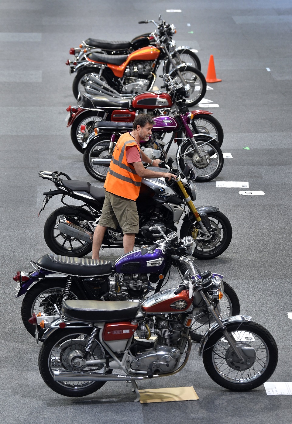 Otago Motorcycle Club member Mark Burrows pushes his 2023 BMW 1250r motorcycle into place ahead...