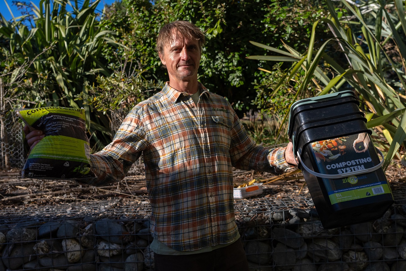 Ben Elms, AKA Dr Compost, with a Bokashi bucket and some Zing activator. Photo: Ruth Blunt