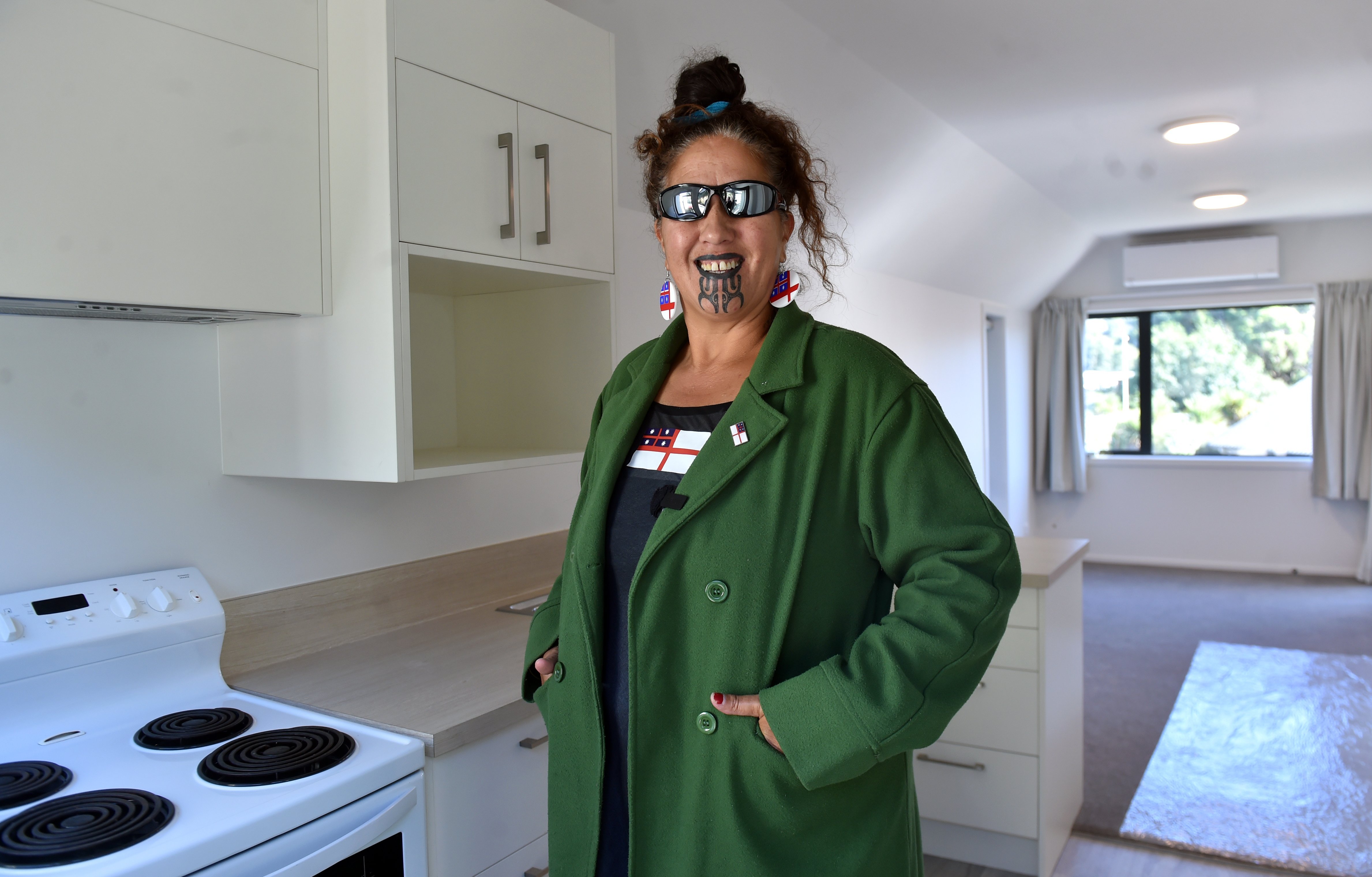 Araiteuru Marae manager Tania Williams shows off the interior of one of the eight now renovated...