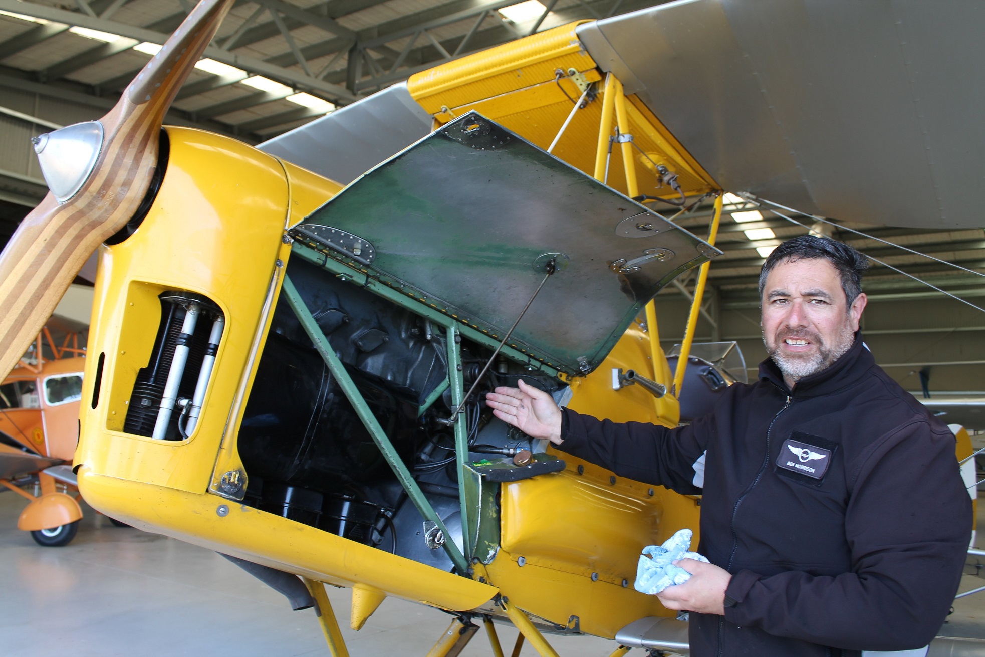 Showing the engine of the yellow Tiger Moth that he will be piloting at the Mandeville Fly-in...