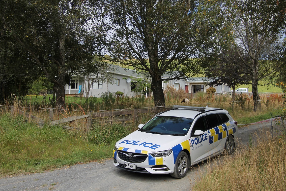 Police guard the house in Hunt Rd, South Otago, that Michael Dunlea was found dead in yesterday....