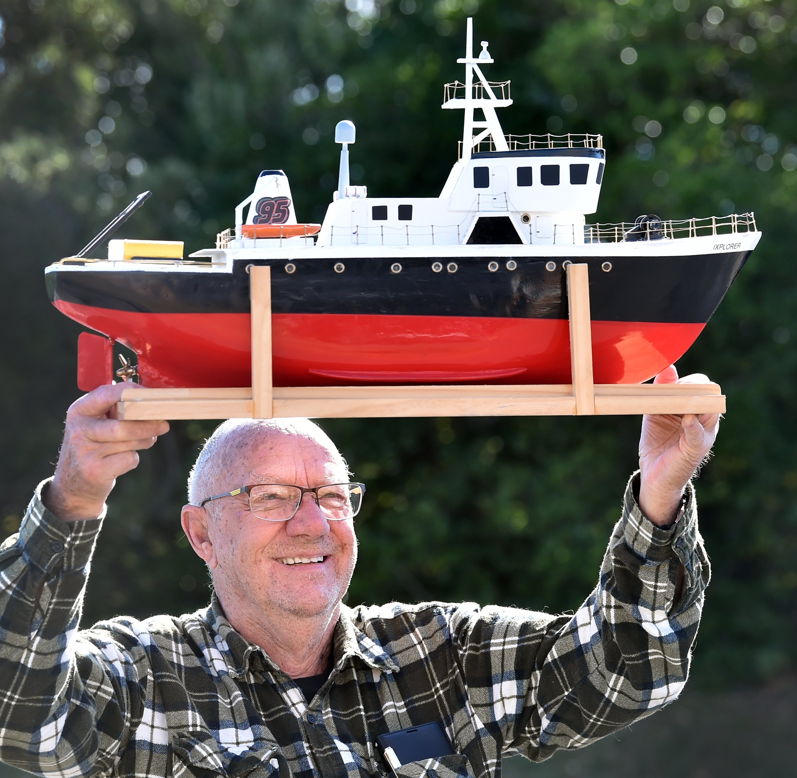 Kevin Gamble of Dunedin carries in his model boat for display at the Model Engineering Expo.