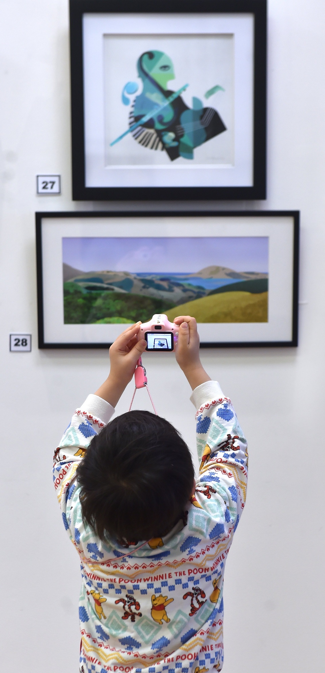 Aspiring photographer Doal Ahn, 4, of South Korea, clicks away on his camera as he and his family...