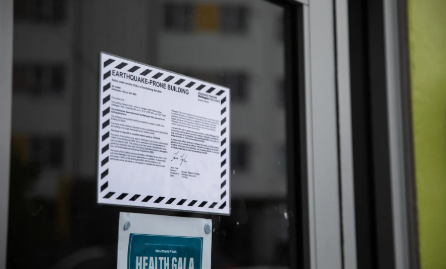 An earthquake strengthening sign at the apartments. Photo: RNZ