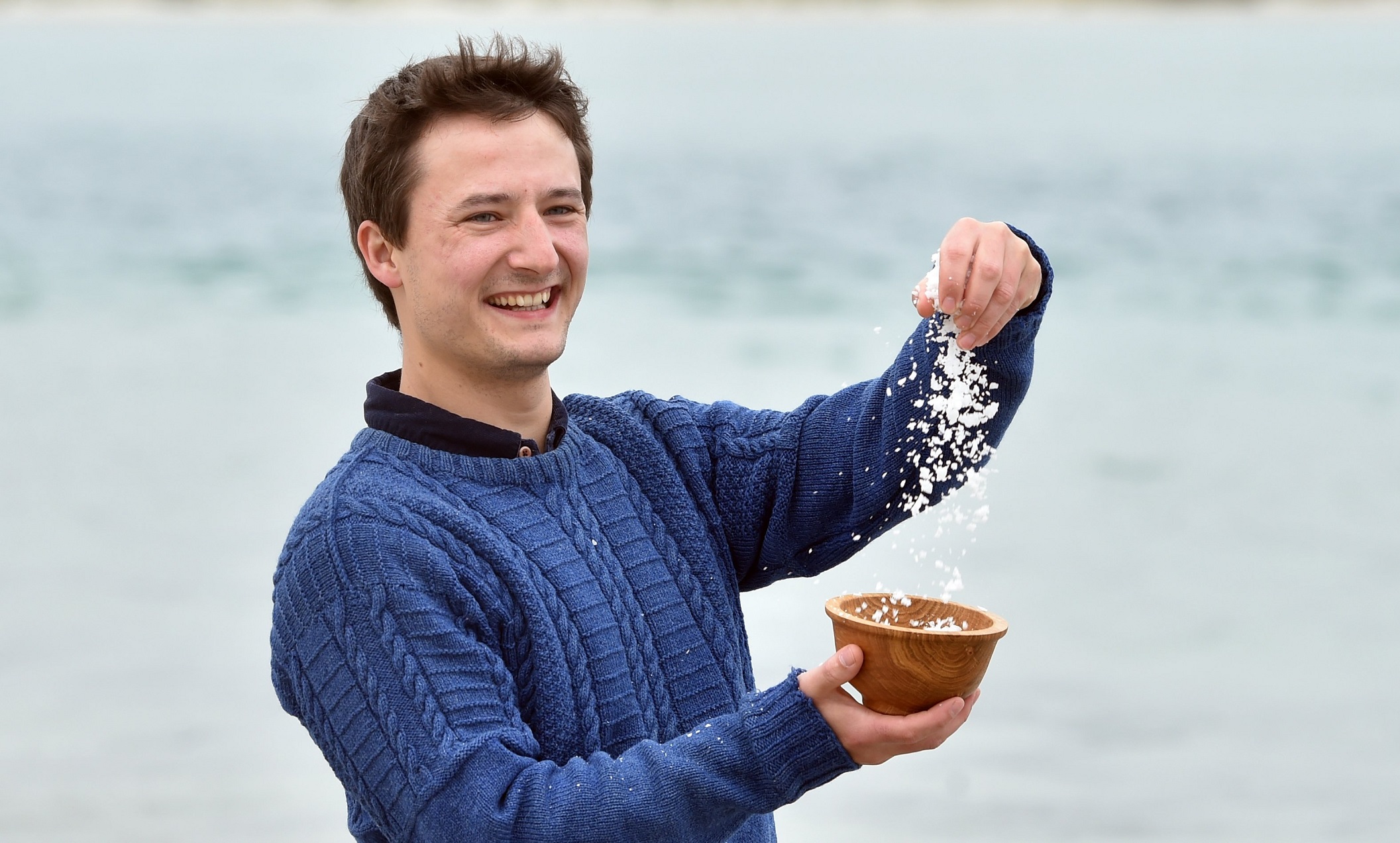 Dunedin resident Bene Stewart sprinkles some of his locally-made salt, made from sea water from...