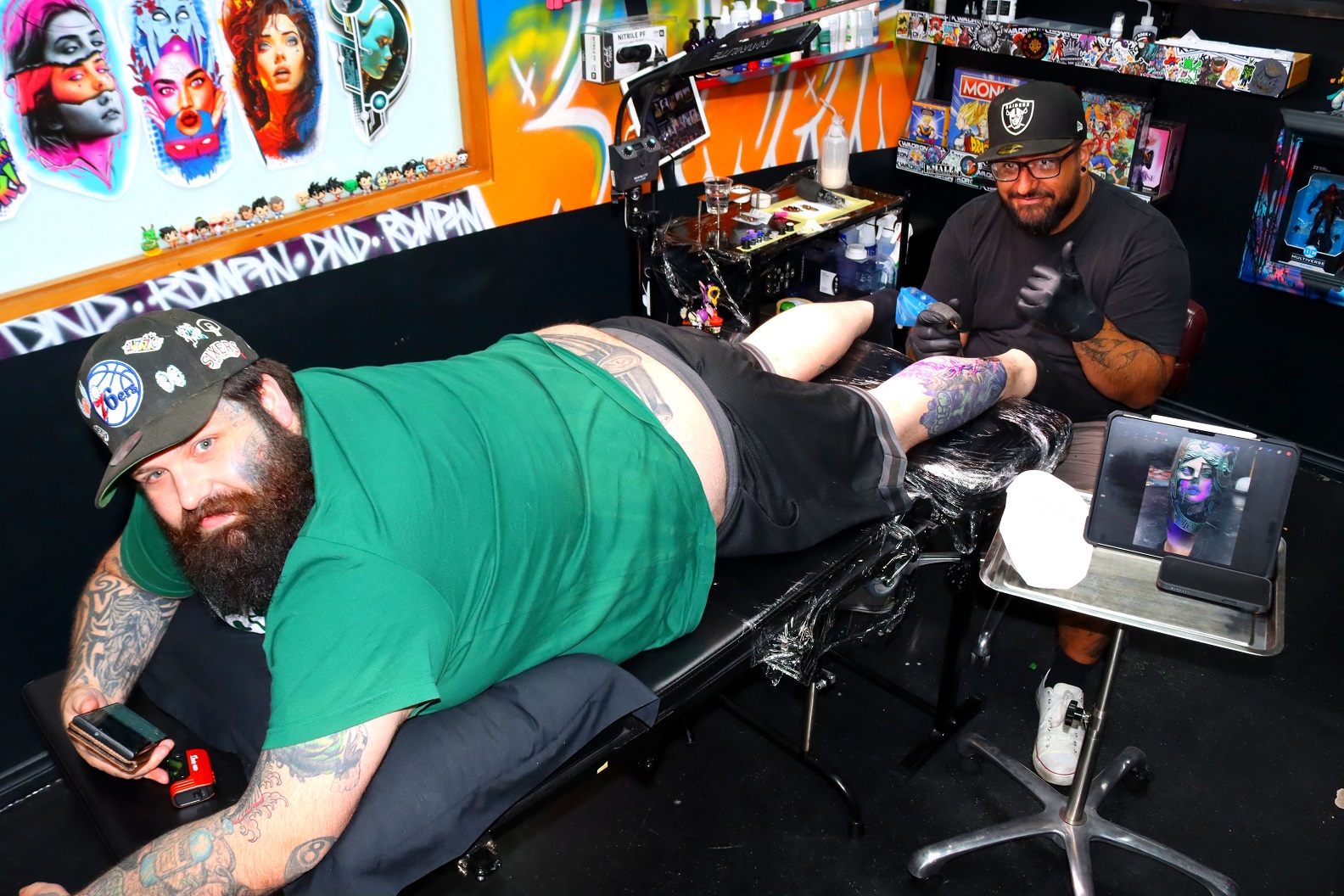 Junior tattoo artist Regan Howells (left) relaxes as tattooist Delaney Reuben inks a single...