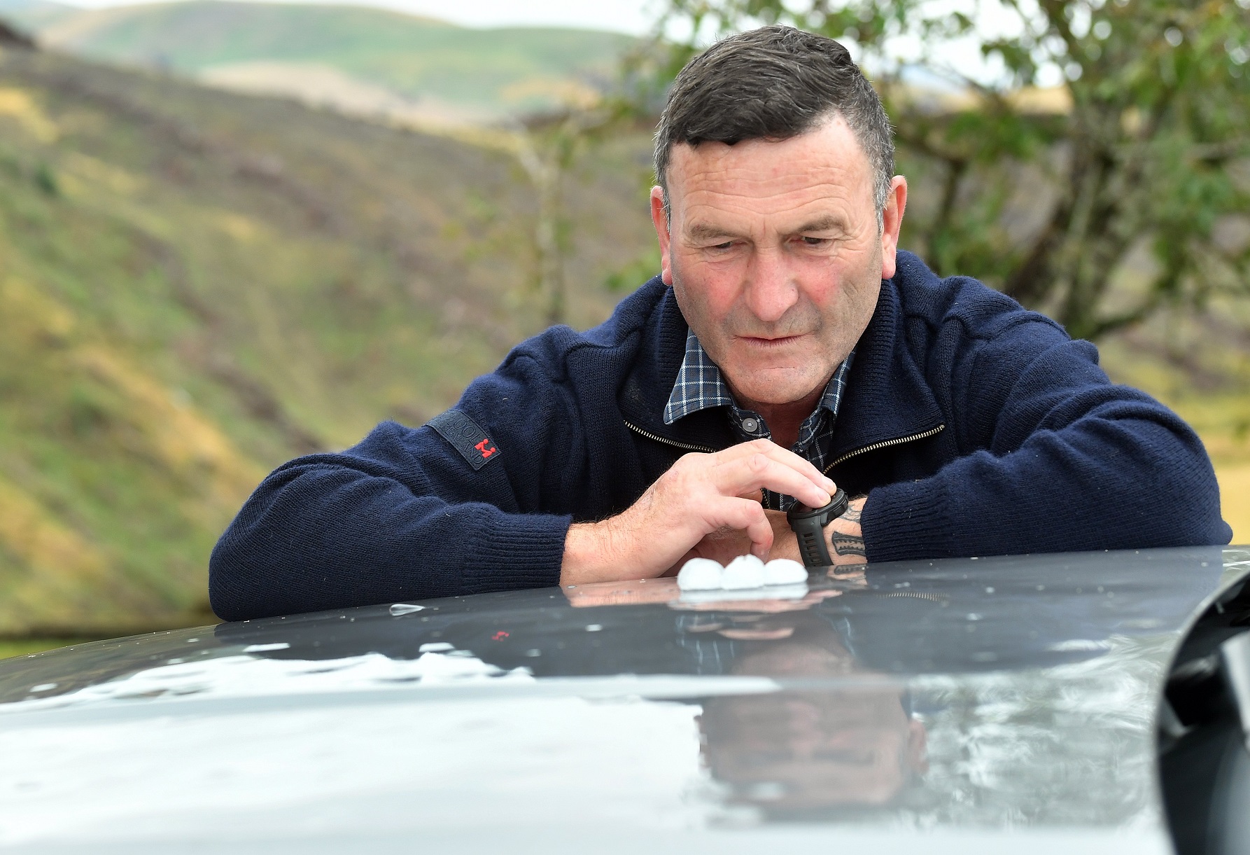 Clutha District Lawrence-Tuapeka ward Cr Jock Martin shows some of the half-golf ball-sized hail...