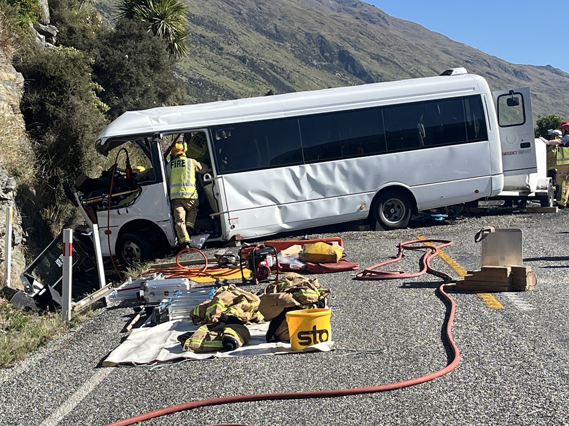 Emergency services remove an injured patient from the scene of a fatal crash involving a bus and...