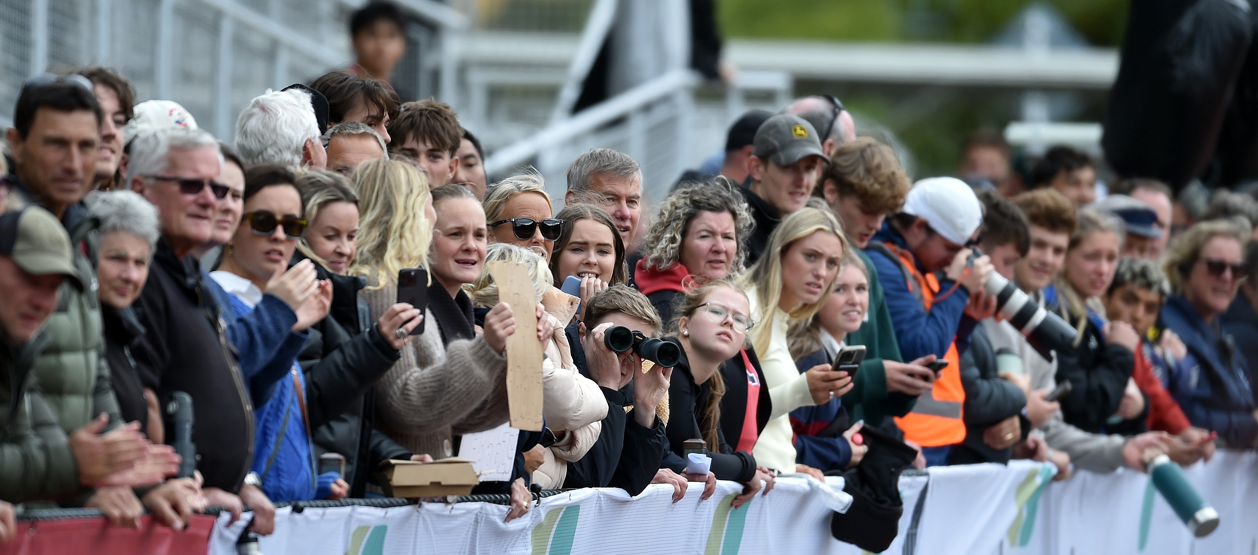 The crowd watch athletes at the Caledonian yesterday.