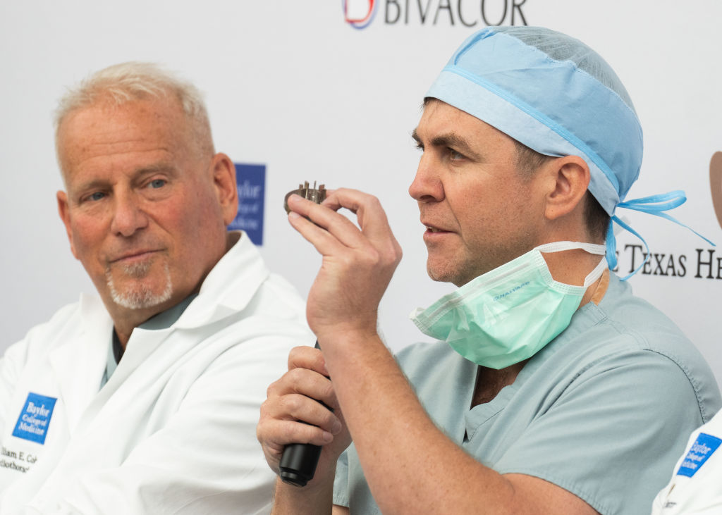 Doctor Daniel Timms, the founder of BiVACOR, holds up a spinning disk component as he speaks...